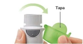A hand removing the green cap from a white medical device for the