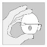 A hand holding a glass vial with a cap and a