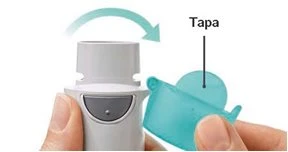 Hands removing a blue cap from a white medical device with a curved arrow indicating rotation to the right