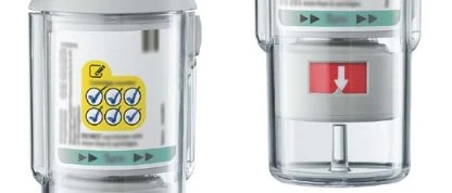 Two transparent medical devices with white and green labels, one displaying yellow control icons and the letter 'l'