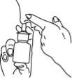 A hand holding a spray bottle while the