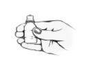 One hand firmly holding a small medicine vial with the thumb resting on the side of the container