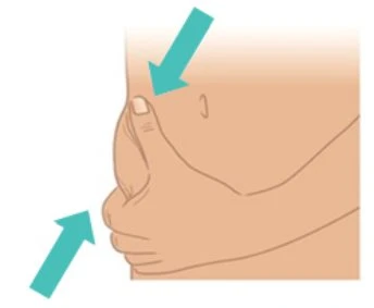 A hand pinching the skin of the