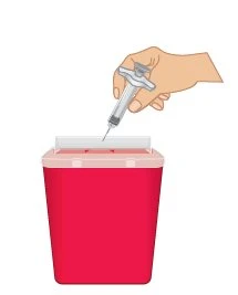 A hand holding a syringe with needle pointing upward
