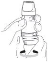 A hand holding a cylindrical medical device while