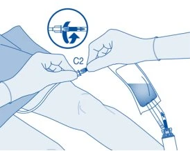 Two gloved hands connecting a medication vial to a device via rotational movement indicated by a blue circular arrow