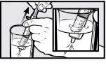 A hand lifts a syringe from a glass of