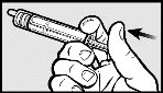 A hand holds a syringe with the thumb pressing downward on the top to activate the mechanism indicated by an arrow