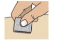 A hand presses a small white adhesive patch onto the skin of the arm or leg to apply transdermal medication