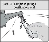 A hand holding an oral dosing syringe under a water stream