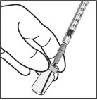 A hand holds a syringe with a needle to aspirate the liquid contained within the