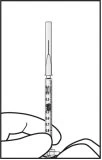 A hand holds vertically a syringe with a needle and graduated barrel for administering a medication