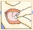 A hand inserting a small white tablet into
