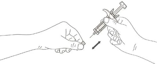 A hand holding a small rectangular object while the