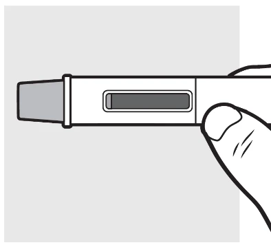 Una mano tiene orizzontalmente un dispositivo medico bianco con una finestra rettangolare centrale che mostra il contenuto interno