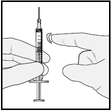 A hand holding a syringe with needle pointing upward