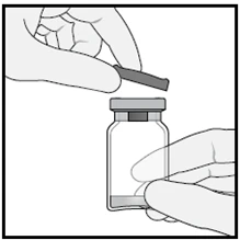 A hand lifting the rubber stopper from a glass vial held steady by another hand