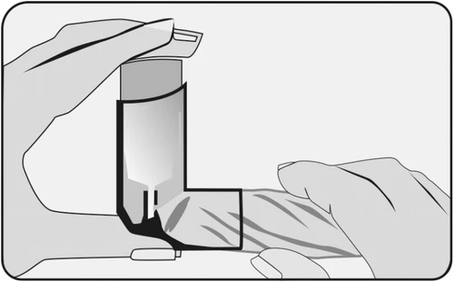 Two hands holding a cylindrical medical device and bringing it close to a striped skin surface for application