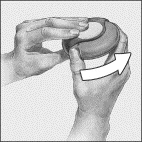 Two hands hold and rotate a circular container to the right, as indicated by a curved white arrow, for