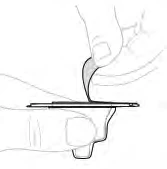 Two hands gently holding and separating a thin strip of material or a tissue flap over a flat, horizontal surface