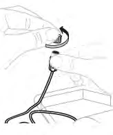 Two hands rotating a toothed circular part of a medical device connected to a flexible tube above a rectangular base