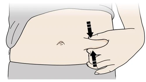 A hand pinches the skin of the