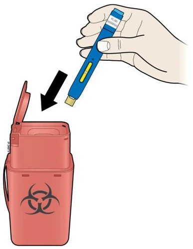 A hand holds a blue injection pen and inserts it into a red container for disposal of biological waste with hazard symbol
