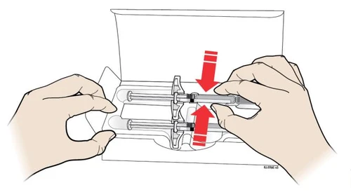 Two hands extract two syringes from a white container with red arrows indicating the extraction movement upward