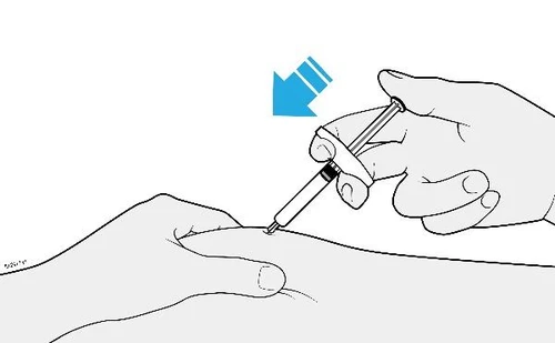 A hand holds a syringe at an angle and inserts the