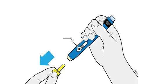 A hand holds a blue injection pen while the