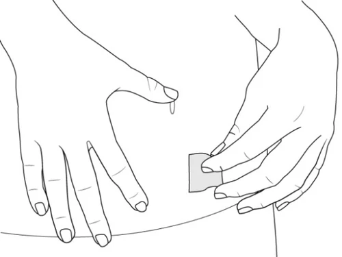 Two hands applying a small rectangular patch onto the skin of the forearm