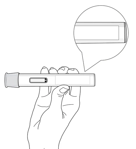A hand holding a cylindrical medical device horizontally with a circular inset showing the inspection window detail