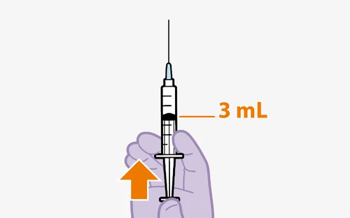 A hand holding a syringe with needle pointing upward