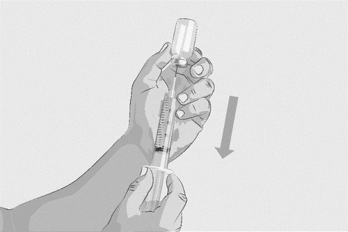 Two hands hold a syringe with needle inserted into a glass vial to aspirate liquid, indicated by a downward-pointing arrow