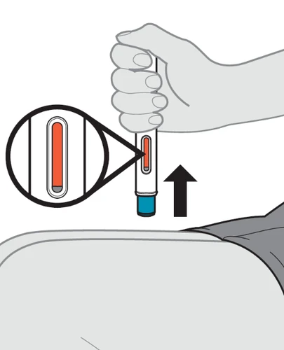 A hand holds an injection pen above the thigh with a magnification showing the level of orange liquid inside