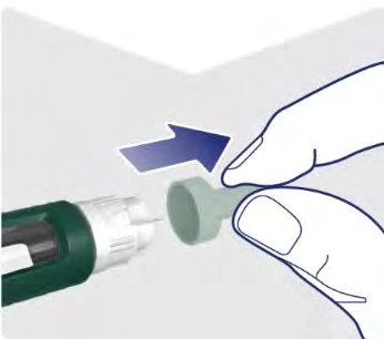 A hand moving a green protective cap away toward the