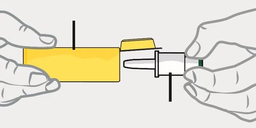 Two hands holding an open yellow vial and a white syringe with a needle to draw the liquid medication