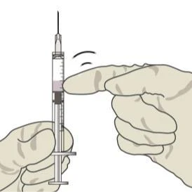 A hand holding a syringe vertically with the needle pointing downward
