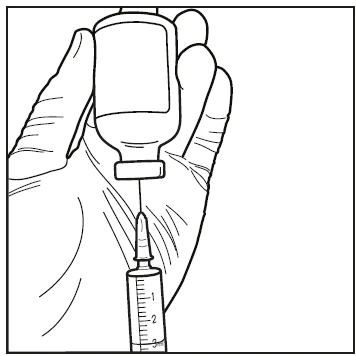 A hand holds a glass vial while a