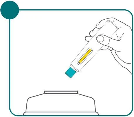 A hand holds a white medical device with a yellow indicator tilted above a white container for the