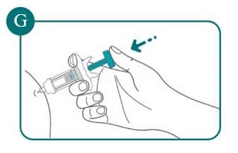 A hand holds a syringe with the thumb on the plunger to inject liquid into the upper arm with a