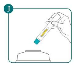 A hand holds a cylindrical medical device with a yellow indicator above a white and blue flat base