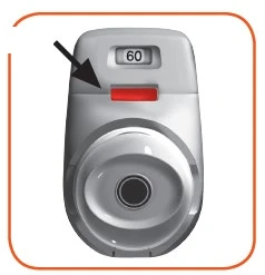 White medical device with a digital display reading 60 and a red button indicated by a black arrow pointing downward