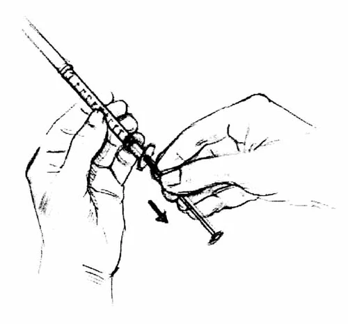 Two hands holding a syringe with the needle pointing towards the