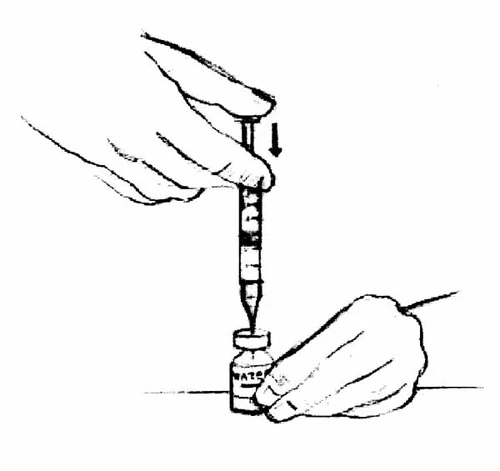 One hand holding a syringe with the