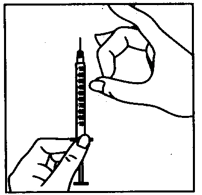 A hand holds a graduated syringe vertically while the
