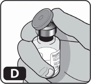 A hand holding a drug vial with open cap for preparation of the medical solution