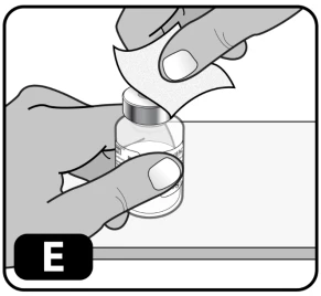 Two hands cleaning the cap of a glass vial with a white disinfectant pad to prepare the