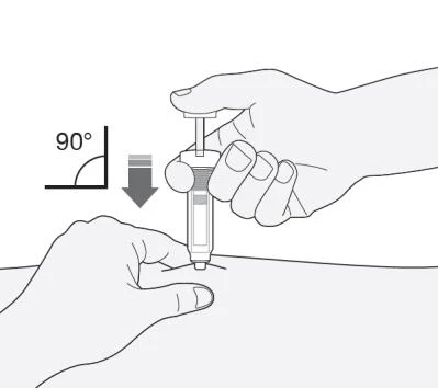 A hand holding a syringe ready for