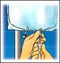 Two hands hold a syringe with a needle to extract contents from a suspended glass vial against a blue and white background